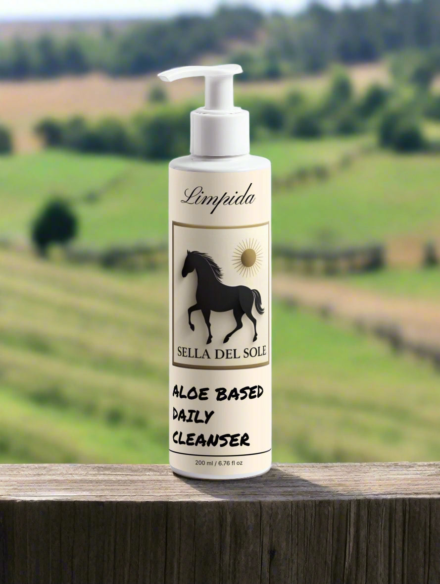 Bottle of Sella del Sole aloe-based daily cleanser on a fence post