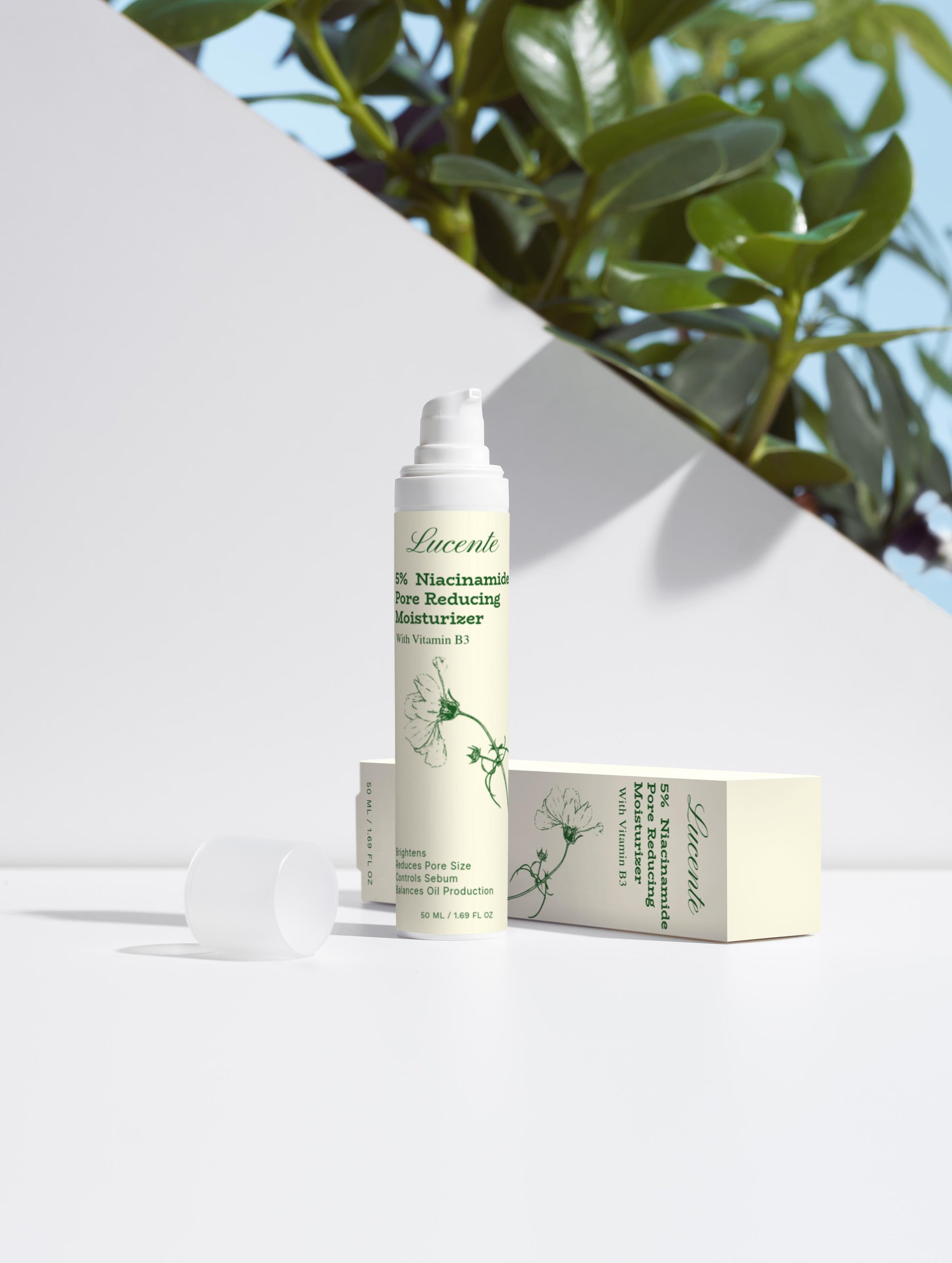 Skincare product with packaging on a white surface with greenery in the background