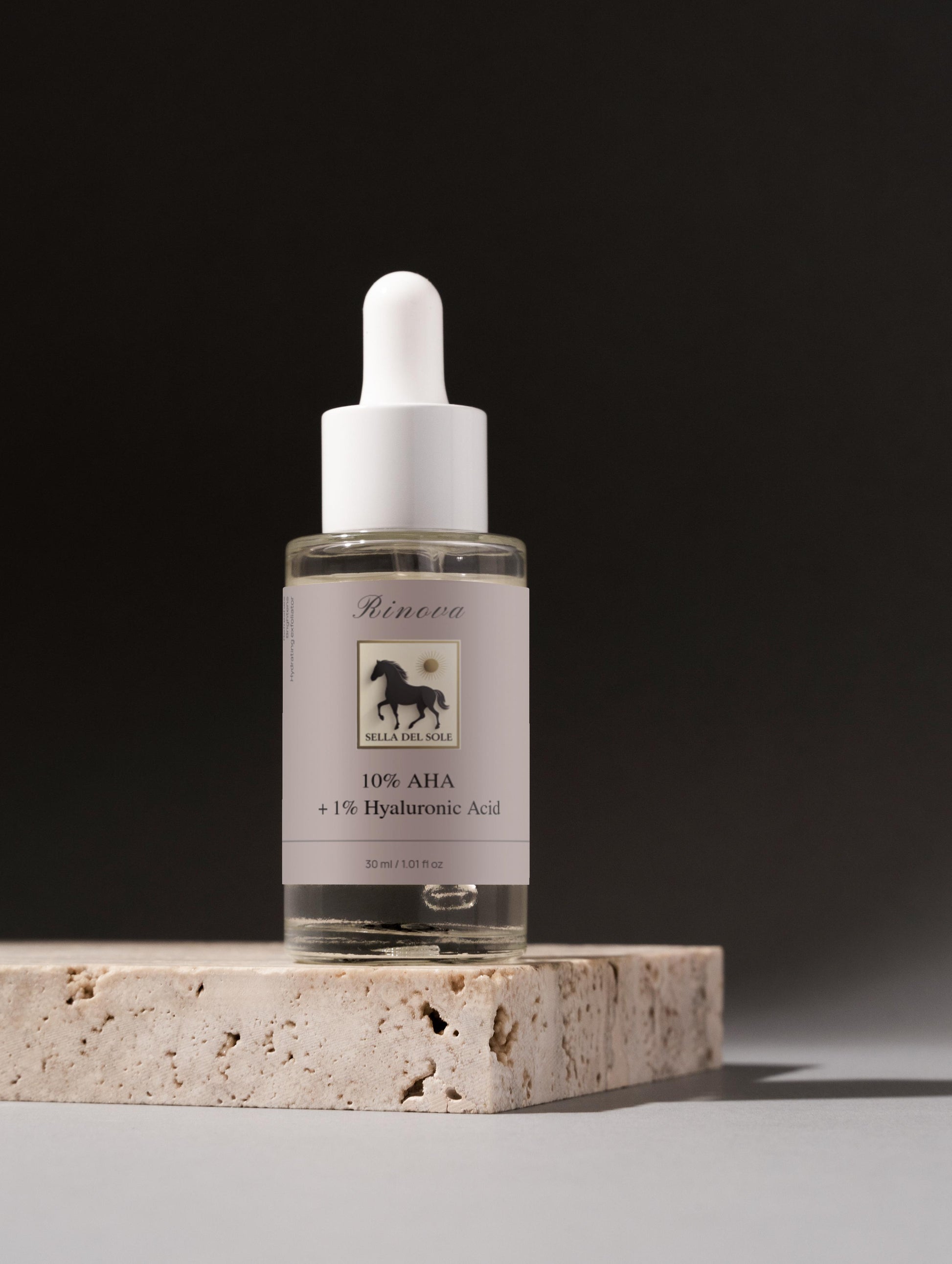 Rinova AHA bottle with dropper on a stone surface against a dark background